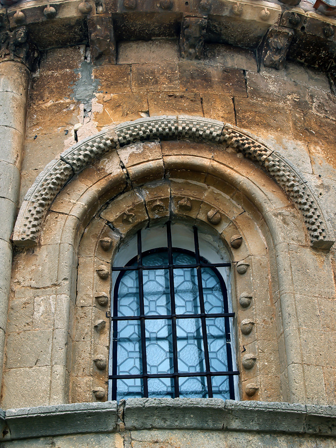 Ventana absidal en la iglesia parroquial de Espinosa de Cervera Burgos con un guardapolvos ajedrezado sobre el arco